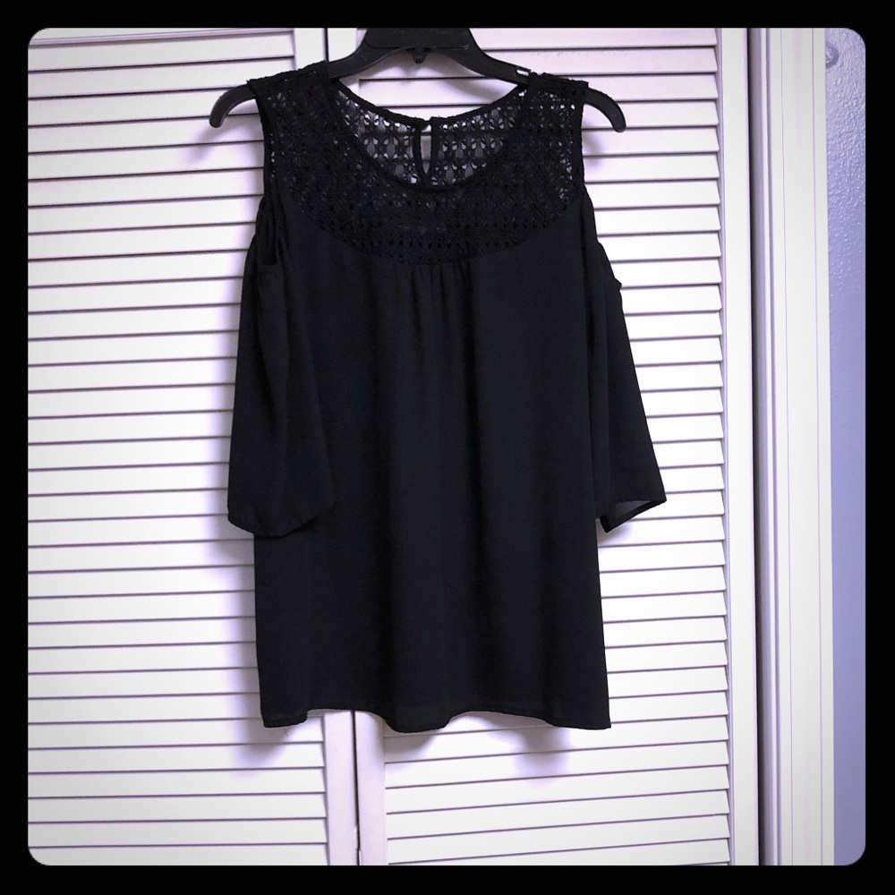 Black open-shoulder blouse.